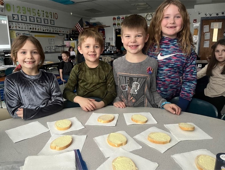 First graders making butter.