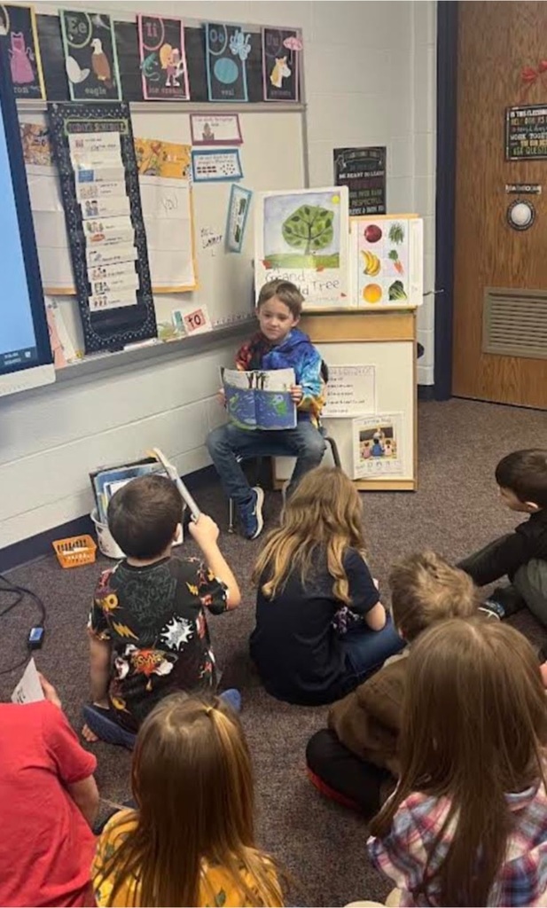 1st graders reading to other students.