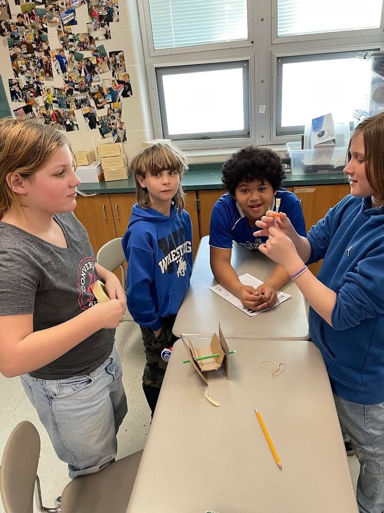 Fifth grade students doing a science experiment.
