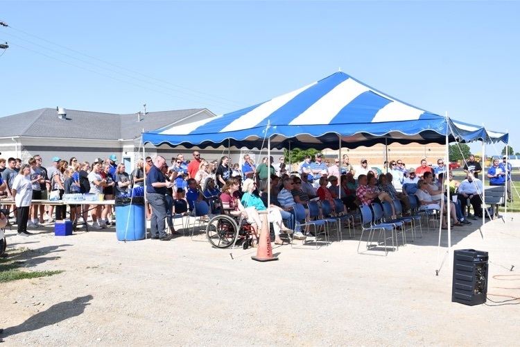 The community gathered for a ground breaking ceremony .